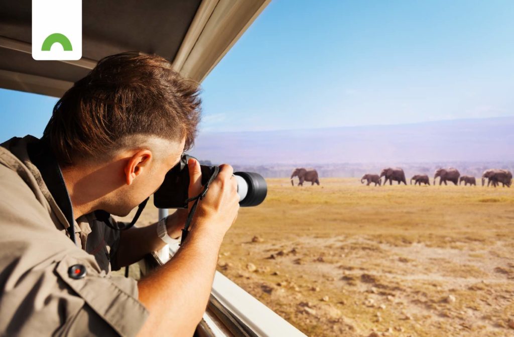 man taking video on safari
