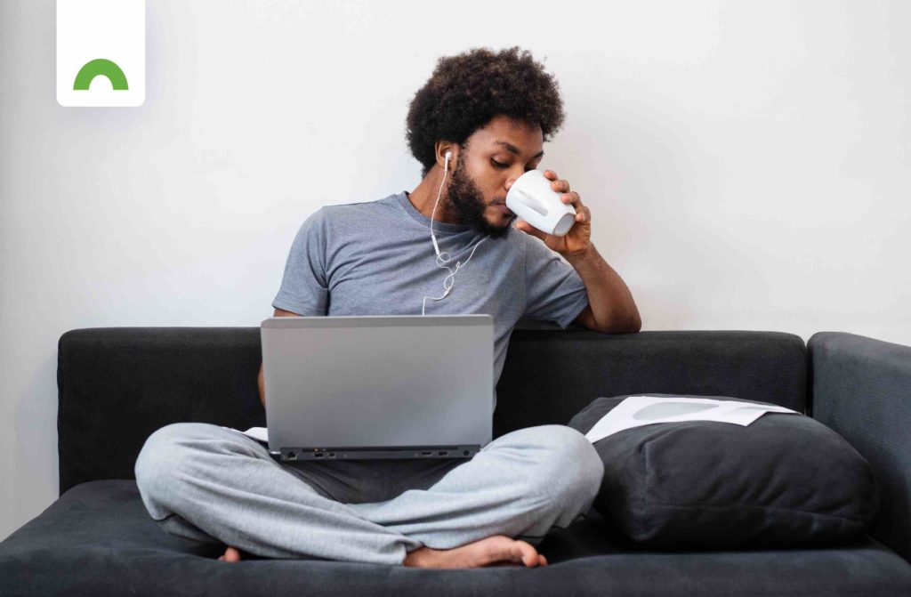 man with laptop and cup