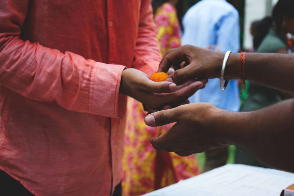 Close-up of hands as one person places a gift into another person’s palm